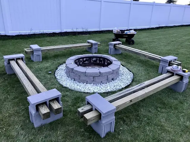 Backyard fire pit with built-in block and timber benches