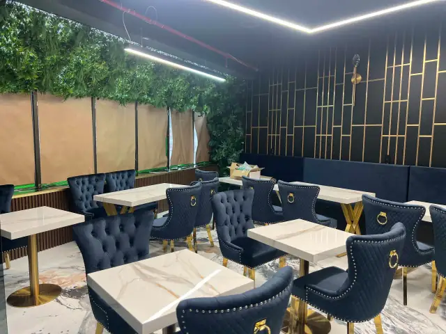 Renovated restaurant dining room with banquette seating and gold accent wall