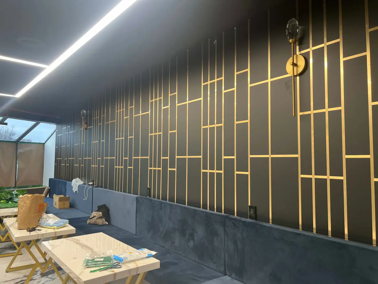 Restaurant feature wall with gold trim and linear lighting