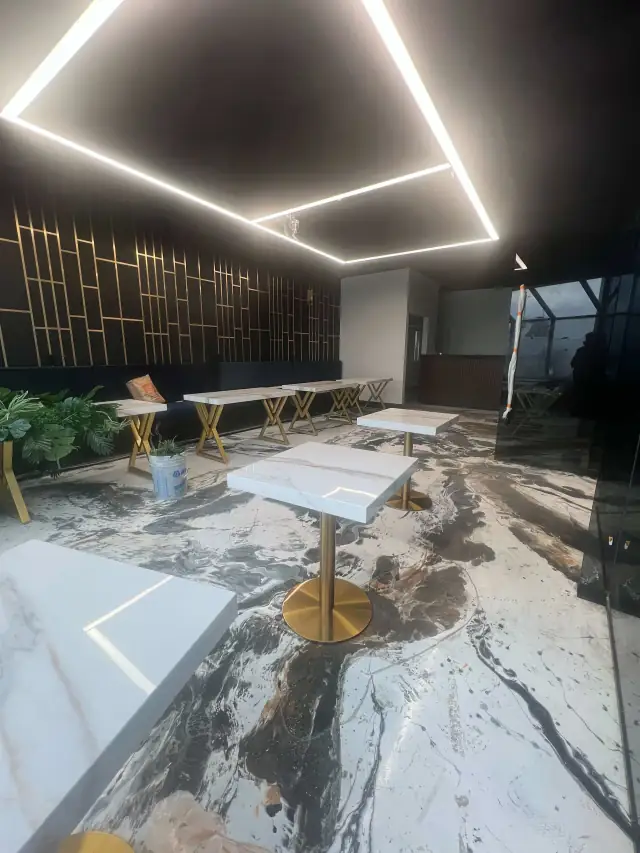 Restaurant renovation with a black and gold geometric feature wall